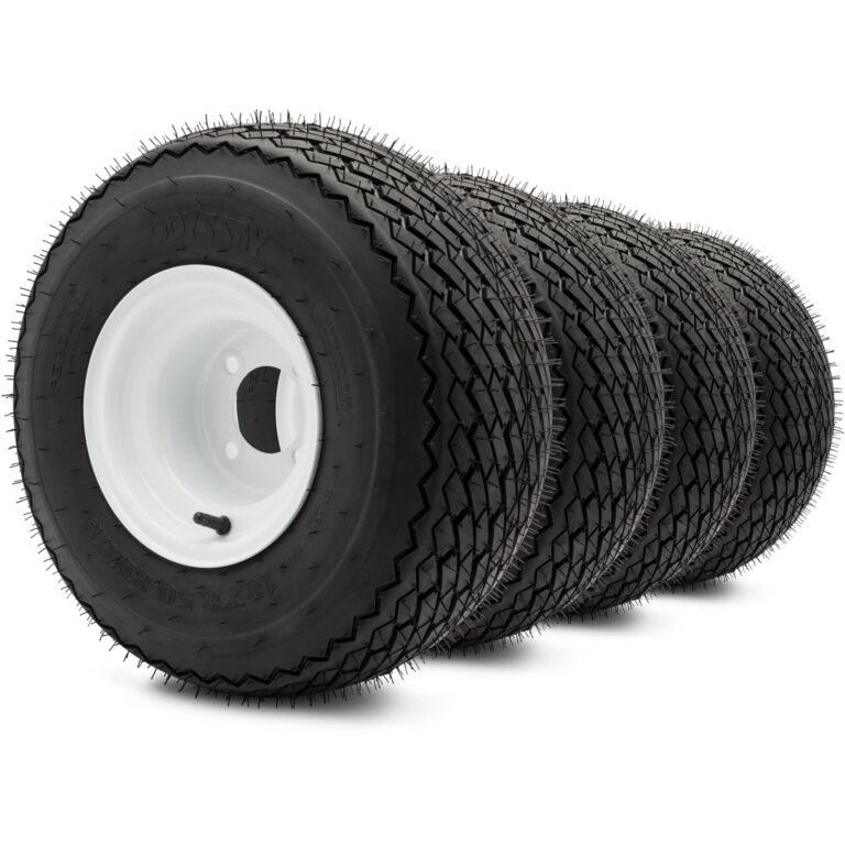 Four black tires with white rims, arranged in a row